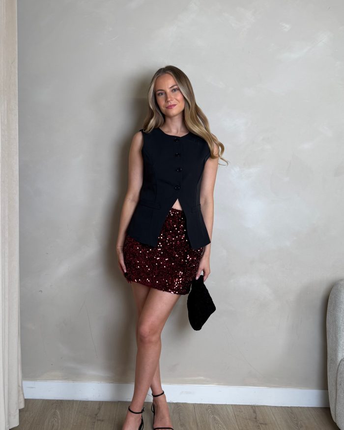 mini burgundy sequin skirt and black waistcoat